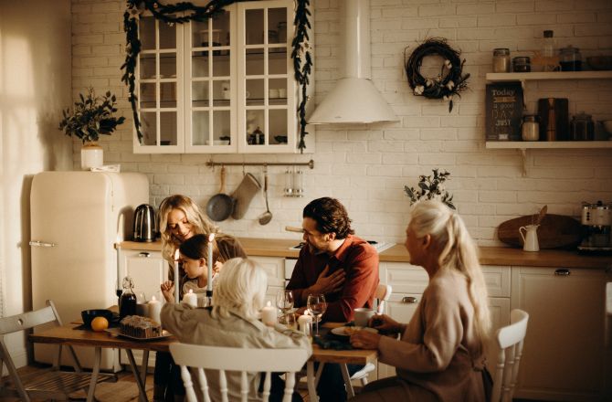 Family Sits On Table Inside Kitchen 3171153