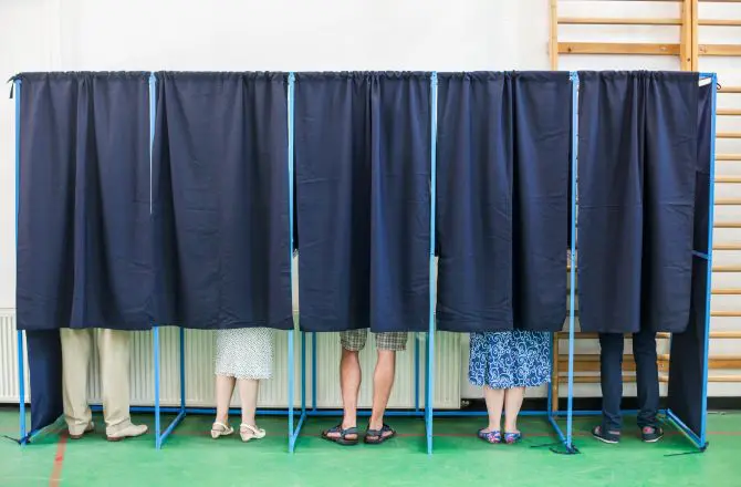 People Voting In Booths